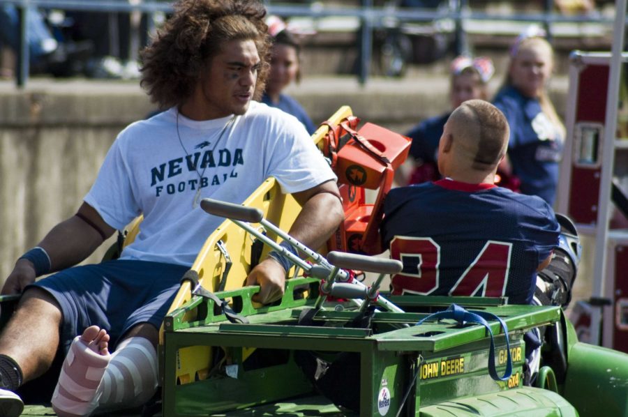 Injured player Mike Tuaua rides a sports medicine cart with a fractured fibula