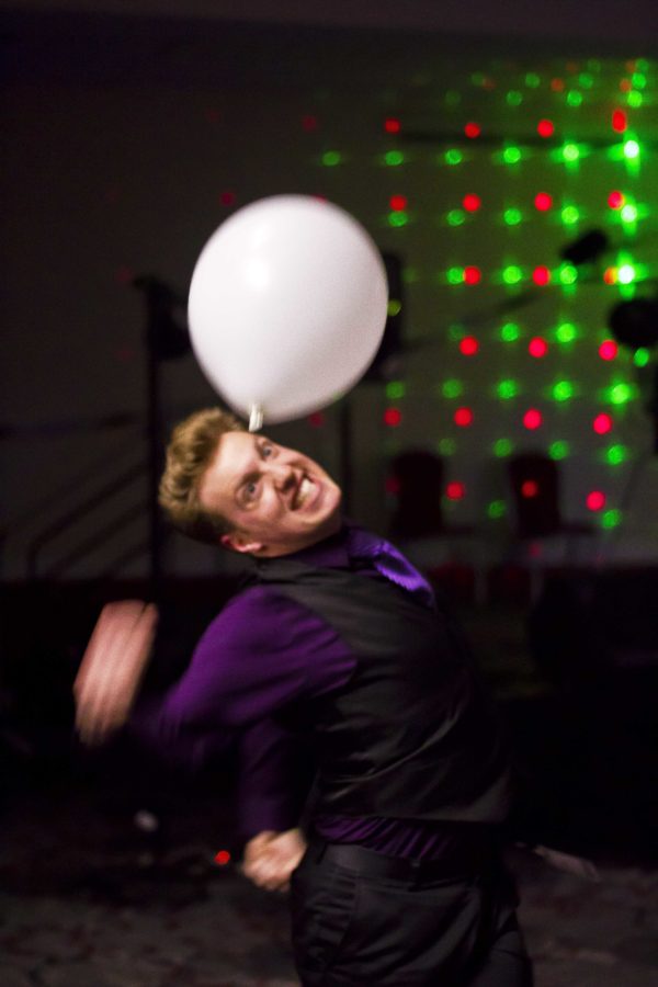 Evan Tremaine-Attwood punches a balloon at the Black and White Ball, the first evening social of the week.