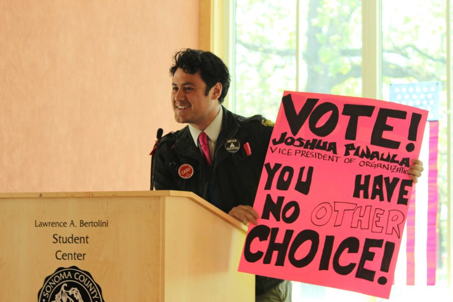 Joshua Pinaula holds his campaign platform proudly in the Associated Student election speeches April 22. 