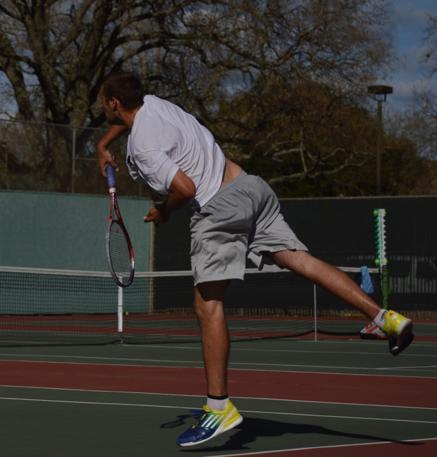 SRJC tennis player Jon Sharp smashes a serve in a match against Grossmont College March 2  at the Izzy Derkos courts.