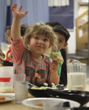 Lily, 3, eats lunch in the Blue Room, one of two rooms for preschoolers at the Robert Call Children’s Center.  