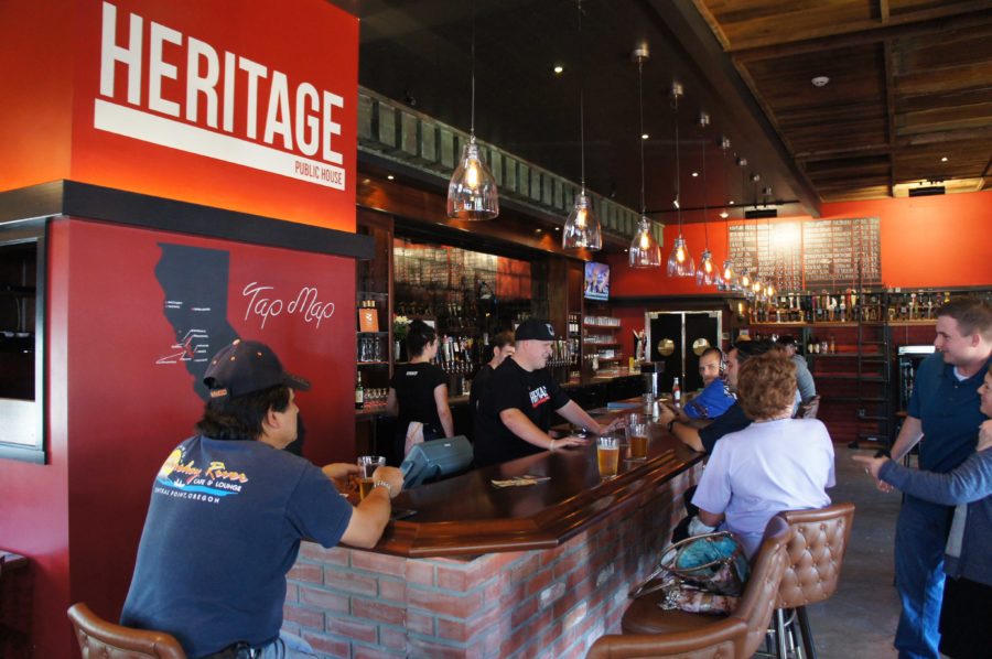 Craft beer enthusiasts crowd the bar as Heritage staff take orders from the 24 rotating California breweries on tap, mapped on the wall at left.