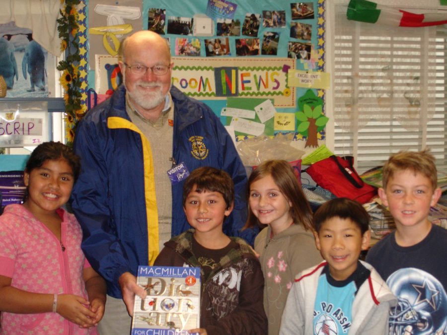 Stephen Olson presents free dictionaries to third graders including his grandson Kolby at Jack London School.