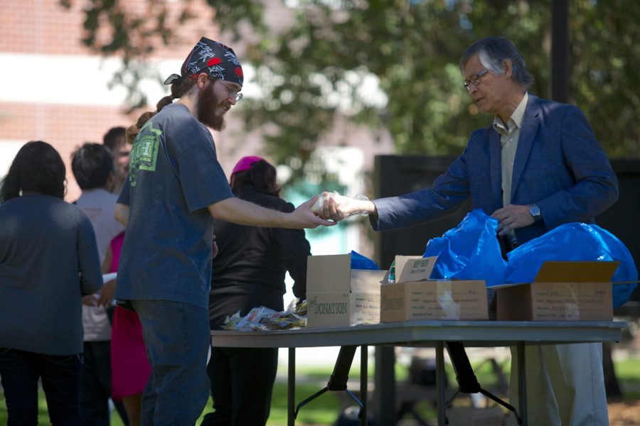 Cody Kyle, 23, a chemsistry major at Santa Rosa Junior College receives frozen burritos from Dr. Ezbon Jen during the first Phi Theta Kappa weekly food bank of the fall semester.
