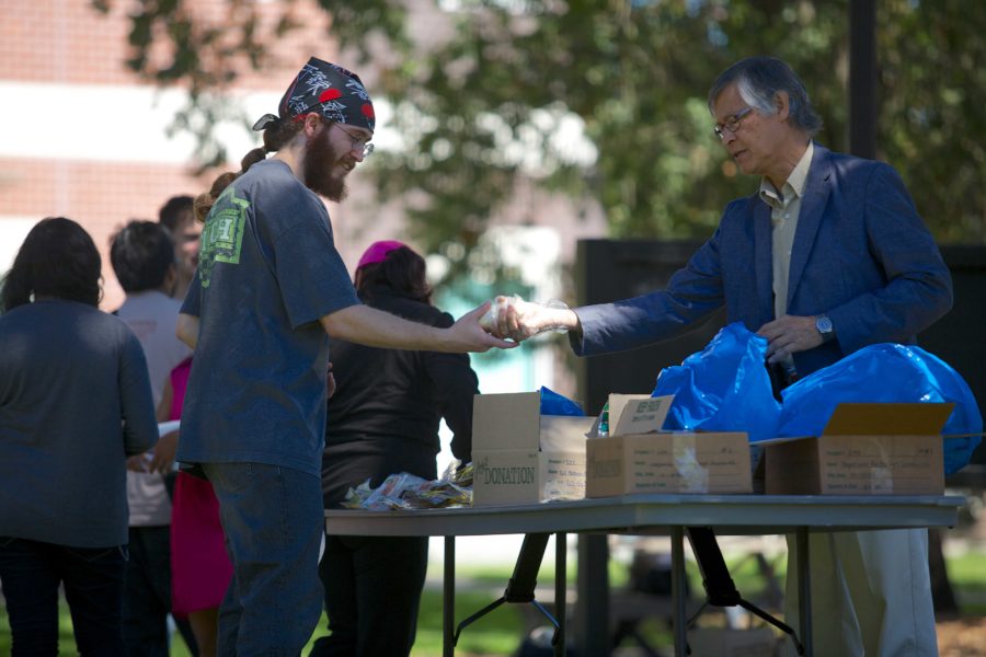 Cody+Kyle%2C+23%2C+a+chemsistry+major+at+Santa+Rosa+Junior+College+receives+frozen+burritos+from+Dr.+Ezbon+Jen+during+the+first+Phi+Theta+Kappa+weekly+food+bank+of+the+fall+semester.