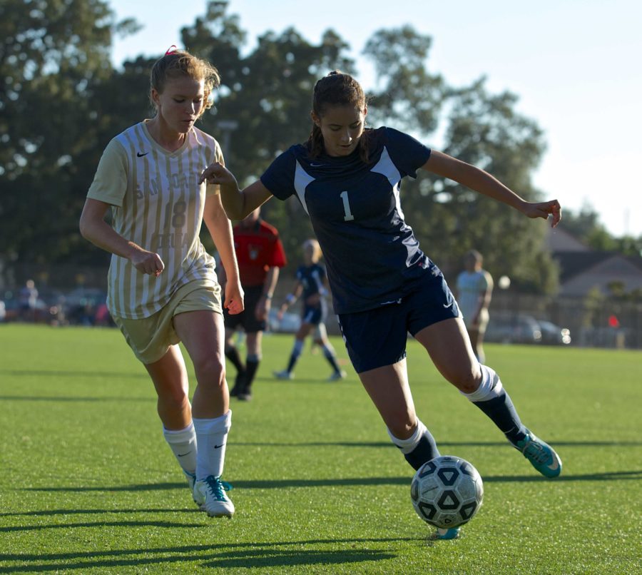 Molly Schuster dribbles the ball away from Delta during an Oct. 11 game.