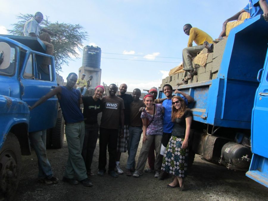 Santa Rosa Junior College Black Student Union members pose with local construction workers in Arusha City, Tanzania.