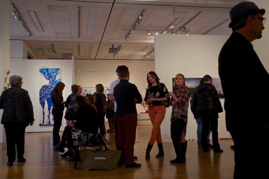 A+crowd+gathers+to+enjoy+the+faculty+art+show+Feb.+20+in+Doyle+Library+Santa+Rosa.