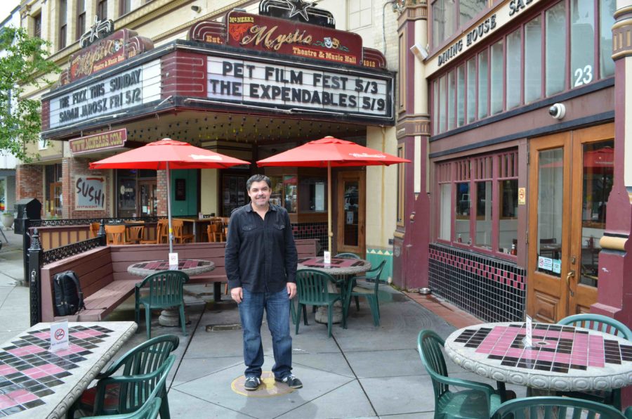 SRJC instructor MIke Traina poses in front of the Mystic Theatre in Petaluma.