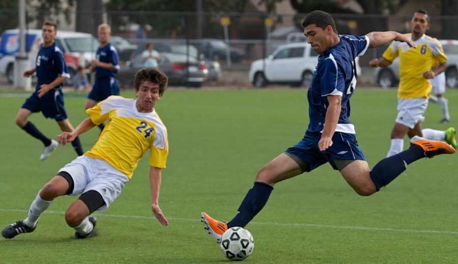 Omar Nuno rifles a shot on net past a diving defender against Merrit College Friday Aug. 29 at Sypher Field, Santa Rosa.