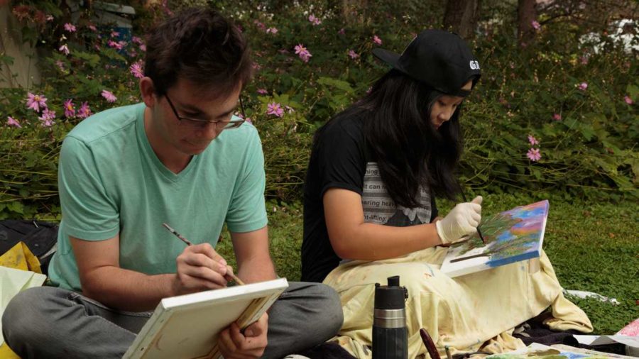  Deborah Kirklin's Art 14 beginning painting students Dylan Stefanisko, 21 (left) and Y Pham, 19 (right) working en plein air this fall on the SRJC campus. (Jeanine Flaton-Buckley/Oak Leaf)