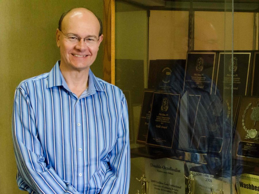 A proud coach, Hal Sanford leads the debate team to several victories since 2012.