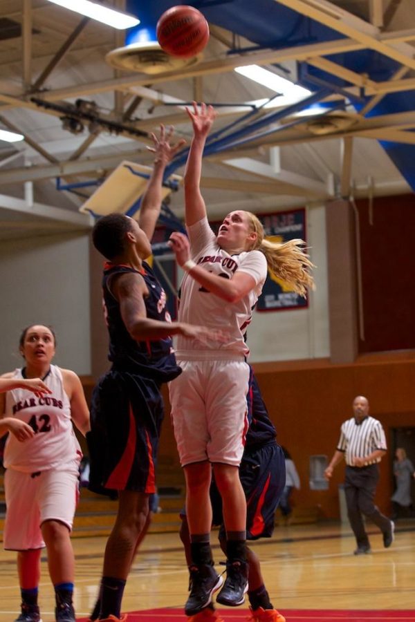 Jenna Dunbar sends the ball to the net over a Cosumnes River Collegedefender Jan. 27 at Haehl Pavilion.