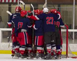 Polar Bears swarm their net minder Dominic Jones after a spectacualr performance and contribution in defeating a D2 Boise State University 5-2 Jan. 22 at Snoopys Home Ice.