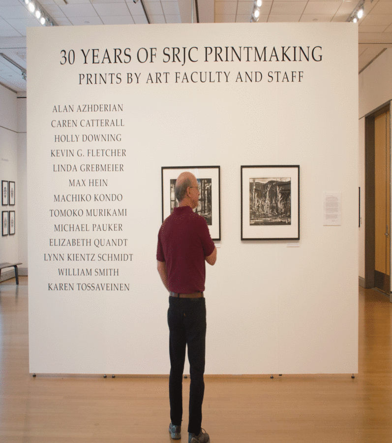 A patron admires prints in the gallery that were made in the 1500s.