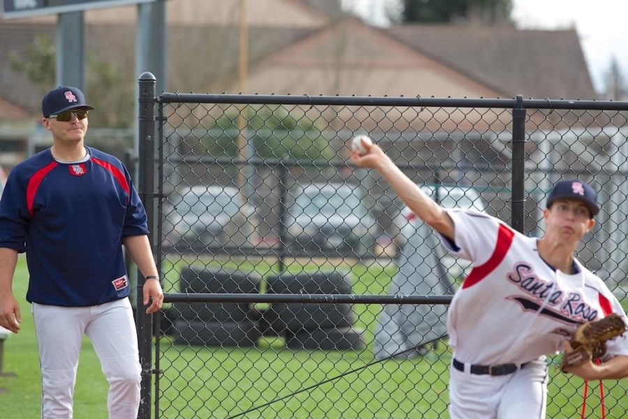 Jonathan Nadele observes Garret Hill take warm up pitches in the bullpen before coming in for relief against De Anza Feb. 5 at Sypher Field.