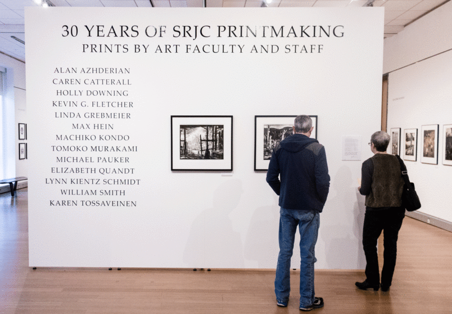 A couple tours 30 years of SRJC Printmaking at the Doyle Library.