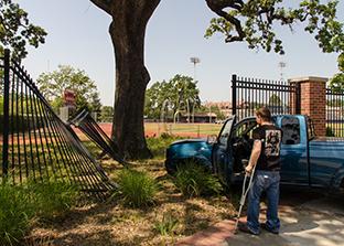 Santa Rosa Junior College student Brett W. looks upon the damange he caused to the fence of Bailey Field after fainting while driving.  