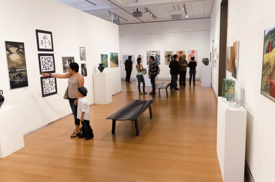 Students and others admire the diverse collection of art on display in the Robert F. Agrella at Santa Rosa Junior College.