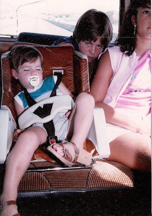 Craig Gettman at age 13 leans behind the shoulder of his younger sister.