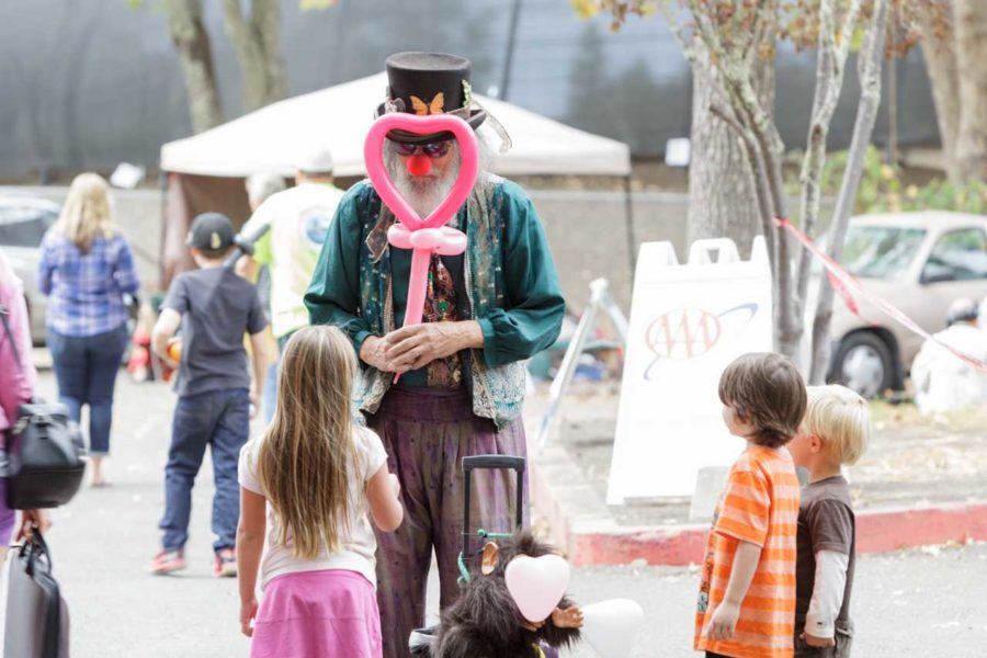 Periwinkle the Clown ties balloons to amuse children displaced by the Valley Fire at the Napa County Fairgrounds in Calistoga Sept. 15. The Valley Fire has destroyed more than 585 homes and the cause of the fire is still unknown, according to CalFire.