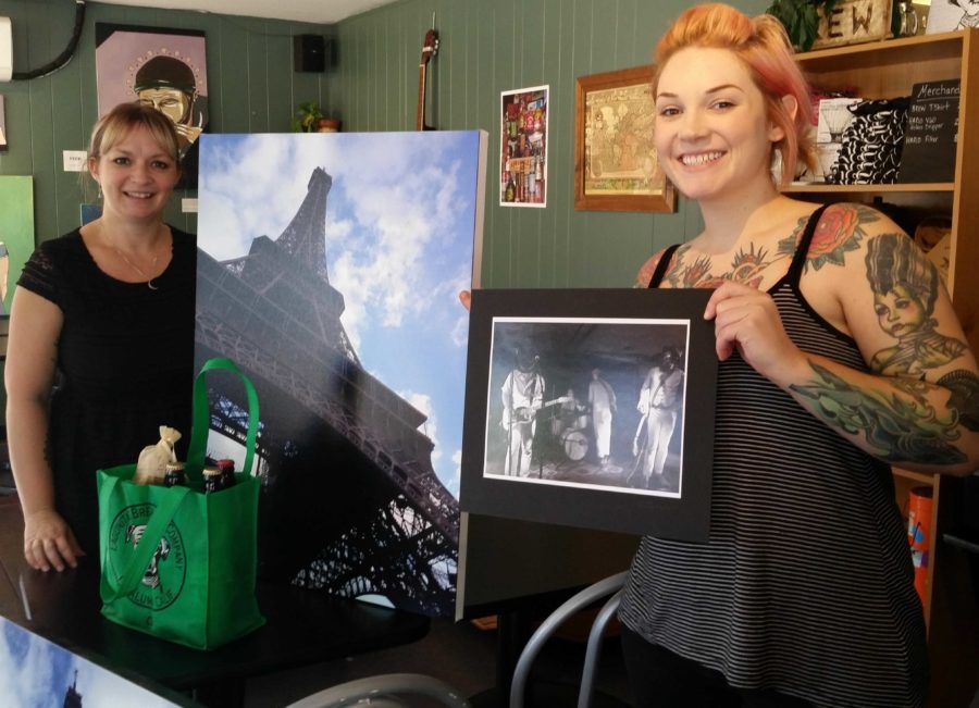 Brew owner Alisse Cottle (left) and employee Loren Hansen (right) pose with some of the items up for auction.