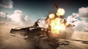 Mad Max and his mechanic lay waste to an enemy vehicle showering the wasteland with fire and scrap.