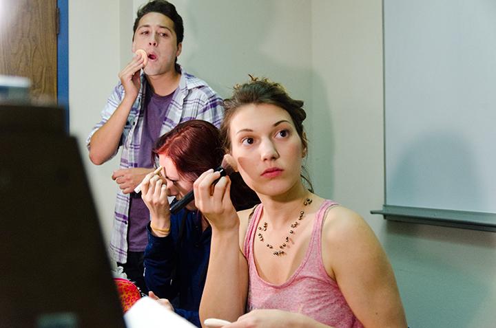 Actors Danny Medina, Christine Vondralee and Peyton Victoria apply makeup before rehearsal on Sept 22 in a backroom of Newman Auditorium.