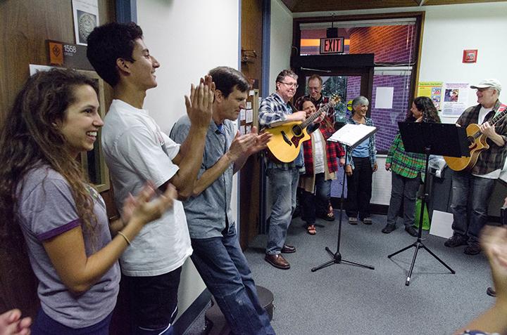 Student actors and director John Shillington applaud as the band Take Jack finishes a performance of their song Long Nights, a song written for the play by group member Chris Smith.