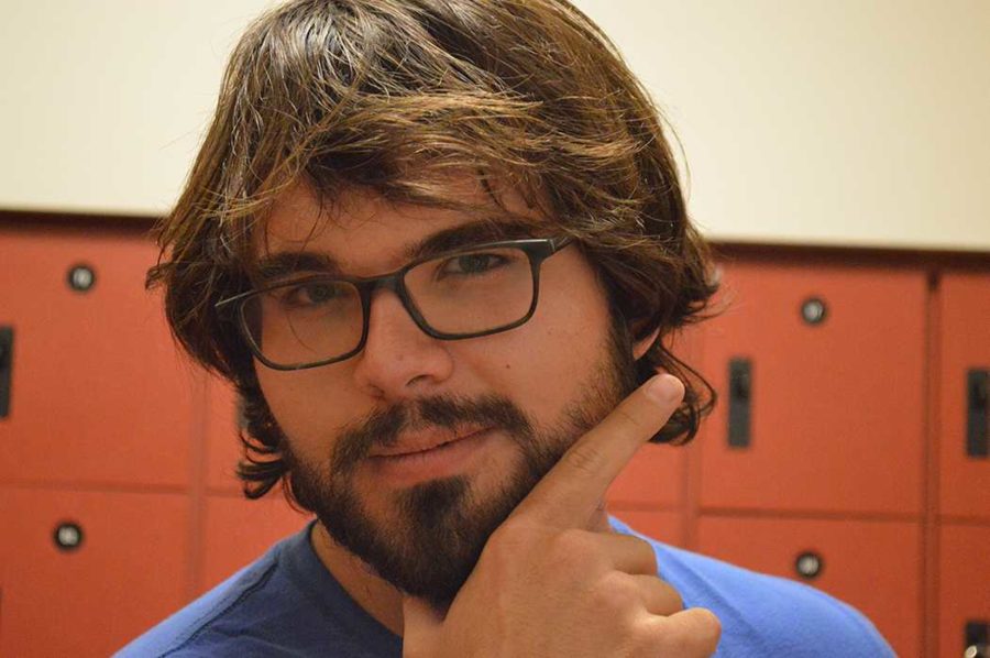 Eric Sadler strokes his beard outside of Bertolini Hall at SRJC. 