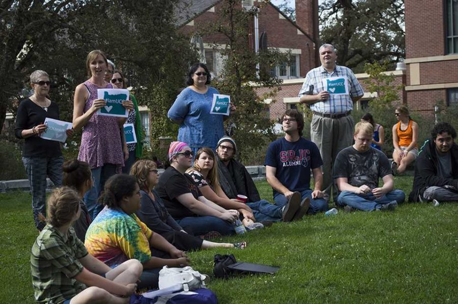 Students sit for the Love-In and SRJC librarians stand with #IamUCC signs.