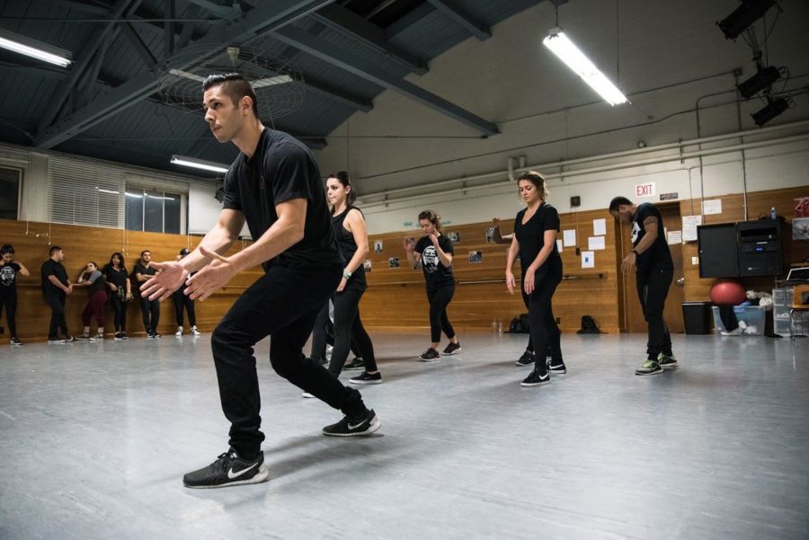 Auxiliary director Chris Medina drills a section of his dance team to perfect a choreography routine in preparation for a future event.   