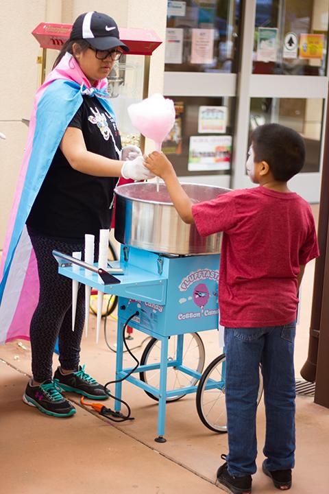 Attendees choose from a variety of carnival-themed food, such as cotton candy and other sweets.