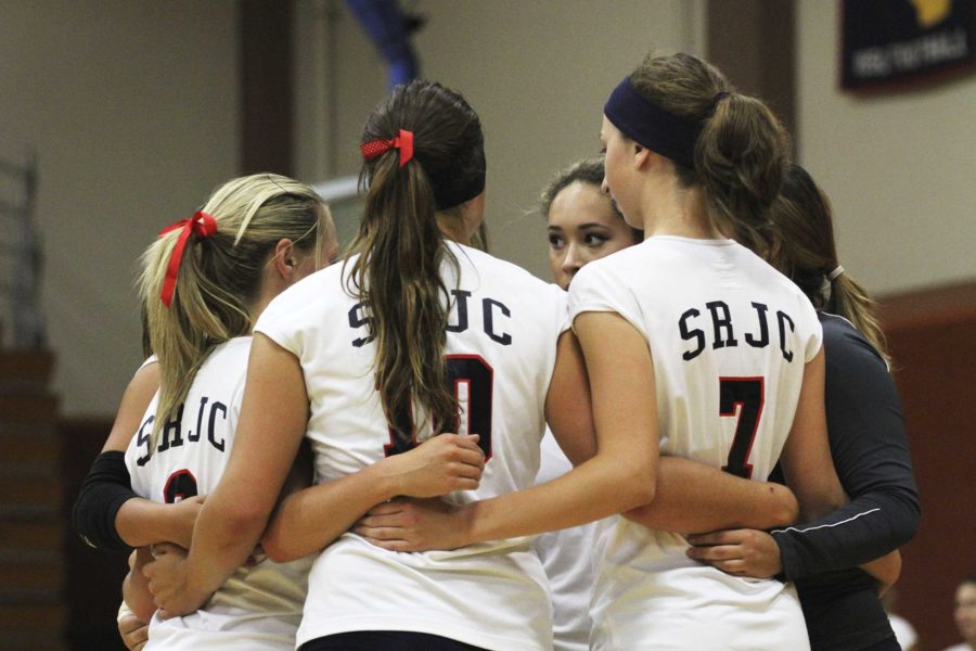 The Bear Cubs volleyball team huddles before a preseason match.