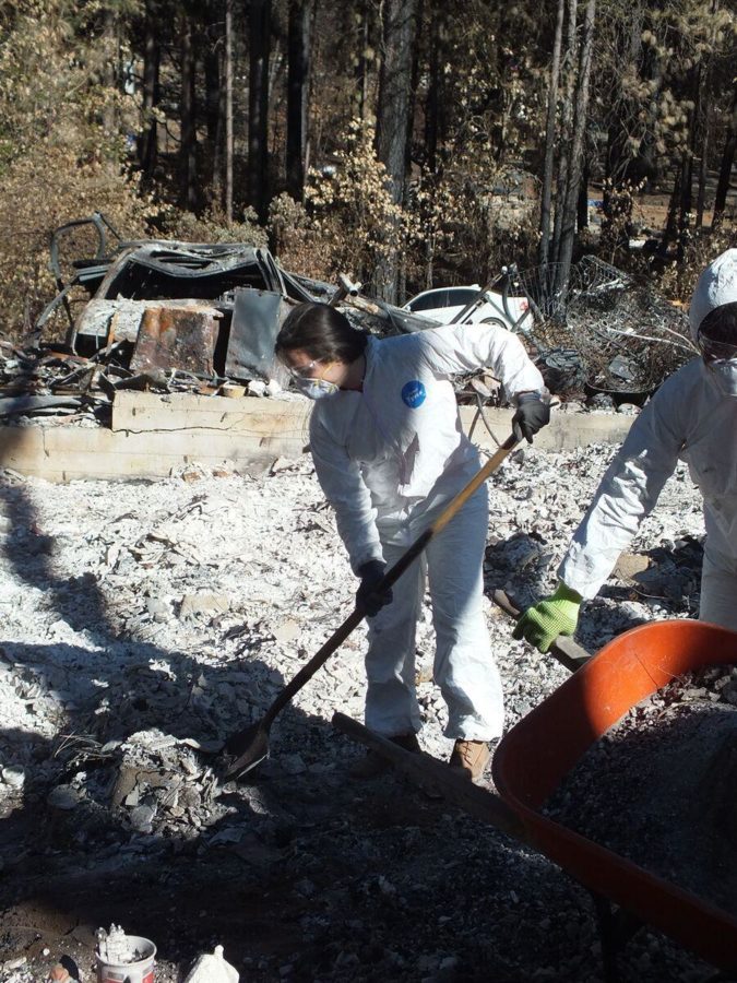 International students dig through the remains of a house burned down in the lake county fire.