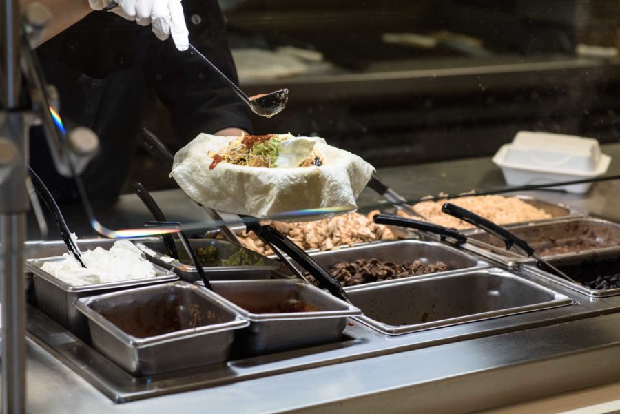 An SRJC employee makes a fresh burrito  at the Santa Rosa cafeteria where students can choose cuisine from different world regions. 