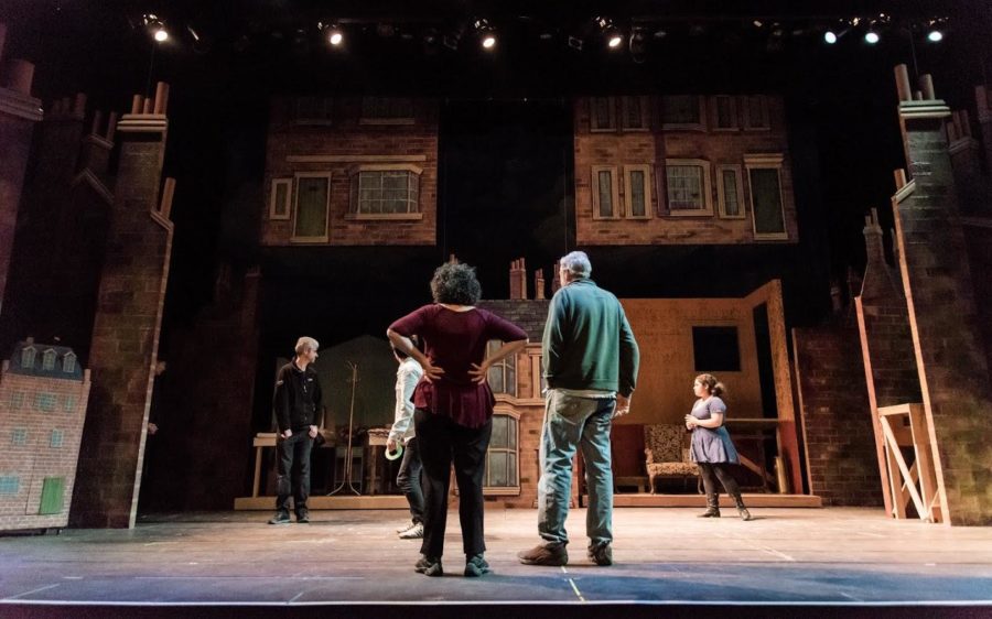 Production Manager Risa Aratyr and Set Designer Peter Crompton survey crew and actors during a tech rehearsal. 