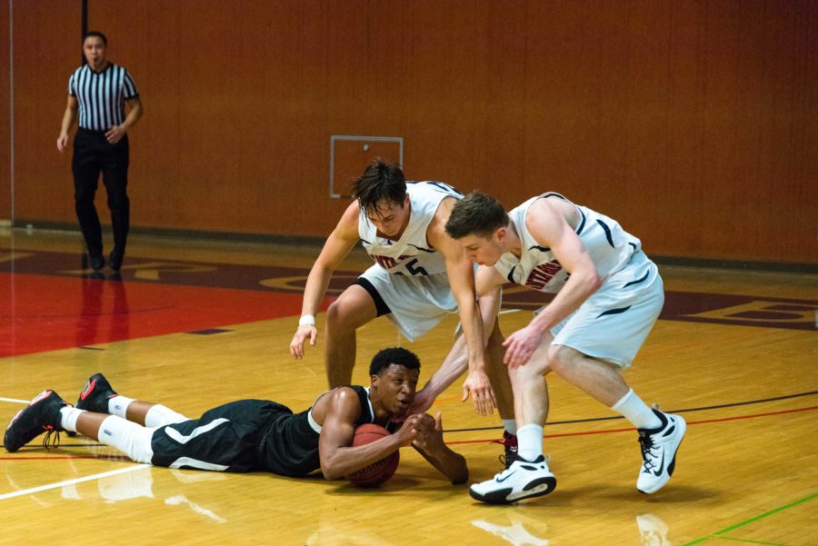 A College of Marin player calls time while laying on the hardwood during a game Dec. 3.
