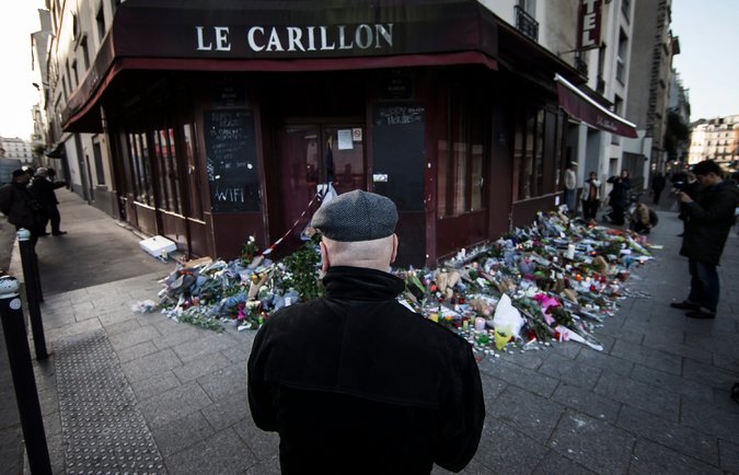 Passers-by pause at one of the sites of the Paris attacks. Many of the terrorists involved in the explosions were French nationals, perhaps reacting to anti-Arab sentiment in France.