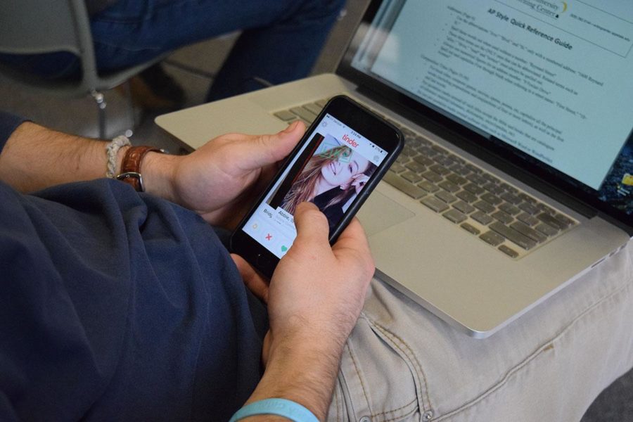 An SRJC student takes a break from  taking notes  to look  for  potential love matches during a classroom lecture. 