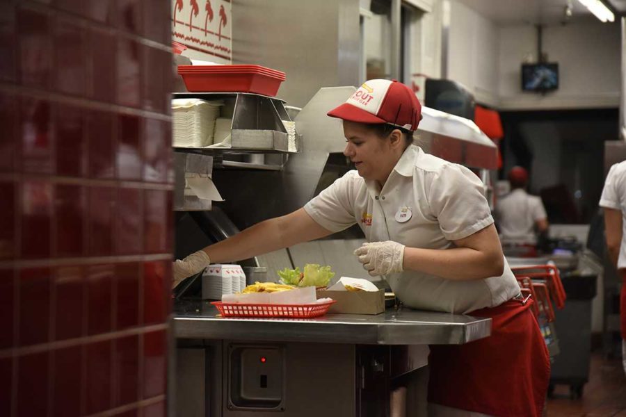 SRJC alumnus Faith Gates works the fryer at In-N-Out Burger. Gates balanced a near full time schedule at In-N-Out with 20 units.