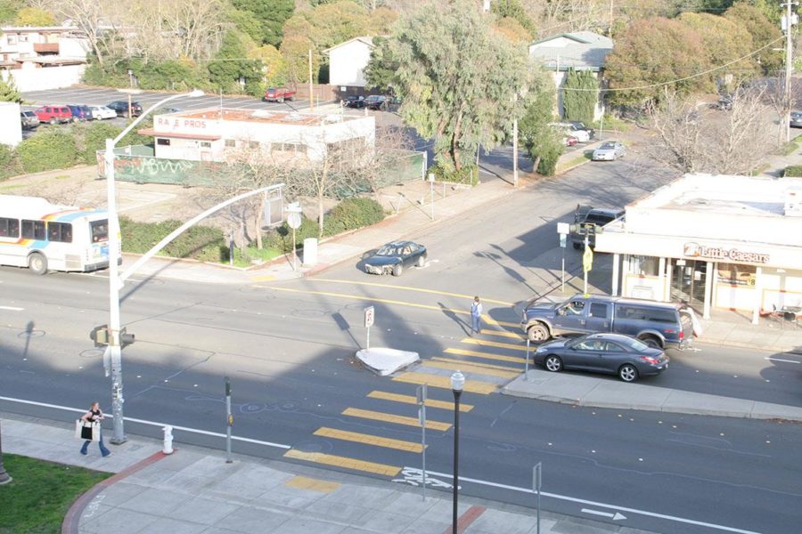 An SRJC student walks through a busy Mendocino Avenue crosswalk.