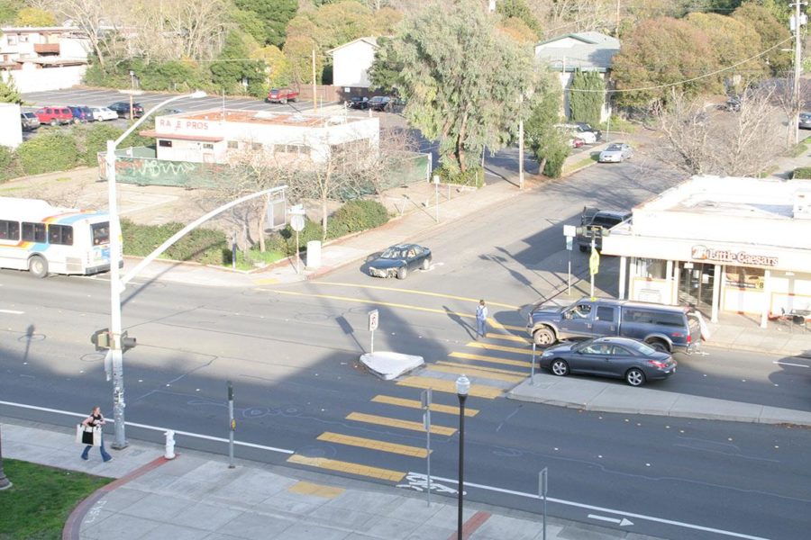 An SRJC student walks through a busy Mendocino Avenue crosswalk.