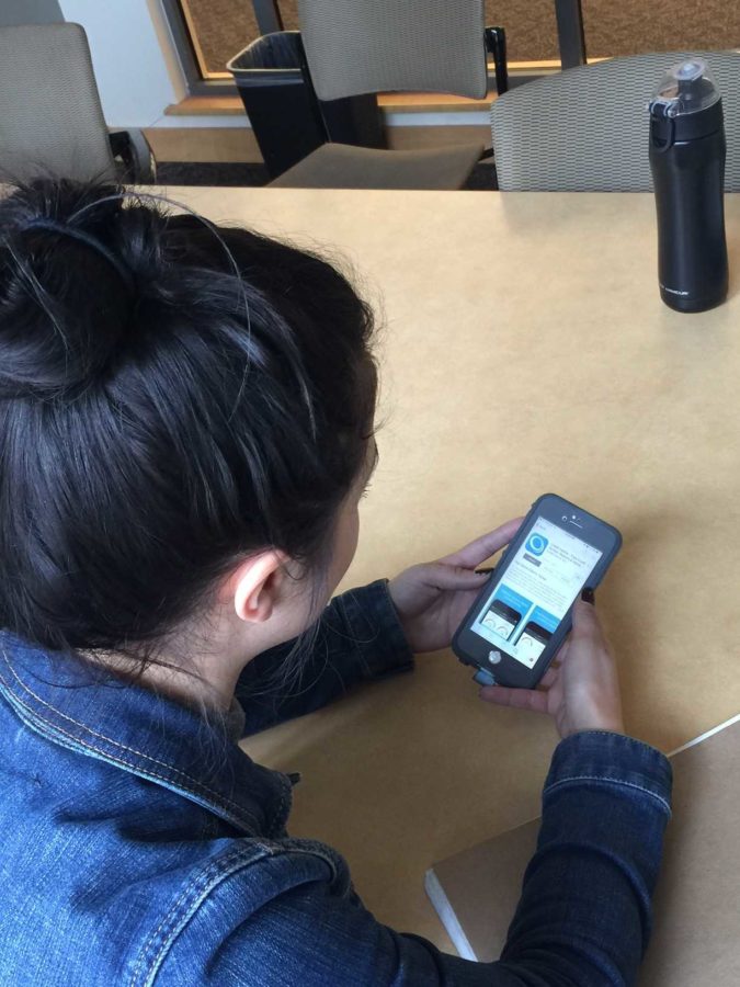 An SRJC student checks the Credit Karma app to view her credit score. Many students are struggling with accumulating debt. 