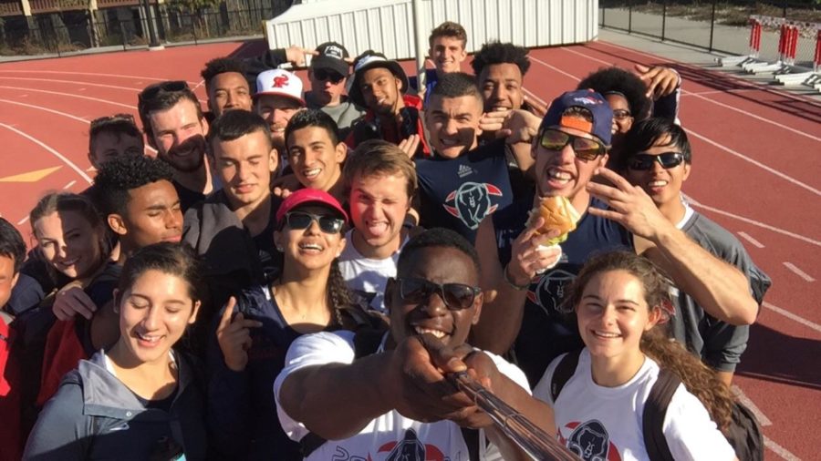 The Santa Rosa Junior College Bear Cubs track team uses a selfie stick to take a team photo on the field after one of  its practices. 