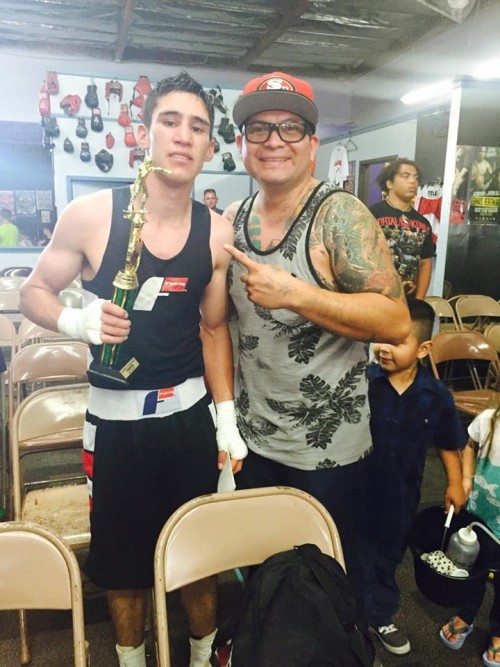 Santa Rosa Junior College student Brian “Hit-Man” Jimenez celebrates another win with his coach Hector. Jimenez balances work, school and a full time commitment to becoming a professional boxer and reaching his ultimate goal of making a name for himself in the super featherweight division. 