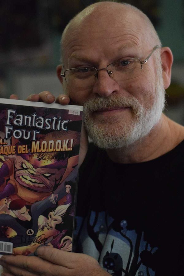 Tom Beland displays an issue of Fantastic Four he wrote. A veteran of the industry, Beland has written for Marvel and DC.