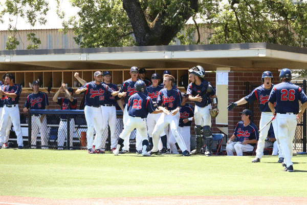 Bryce Nagata, No. 21, comes storming into the Bear Cubs’ dugout after scoring on a two-RBI double by first baseman Ryder Kuhns in the bottom of the third inning.