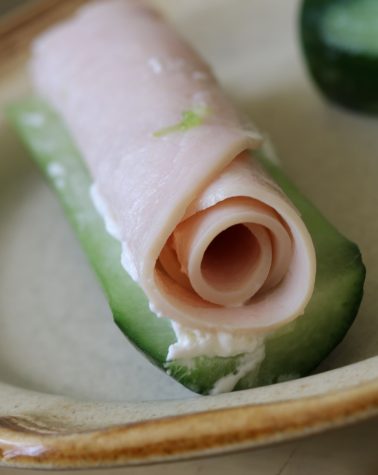 Turkey rolls on a cream cheese spread over a cucumber is the perfect snack for a hot summer day. 