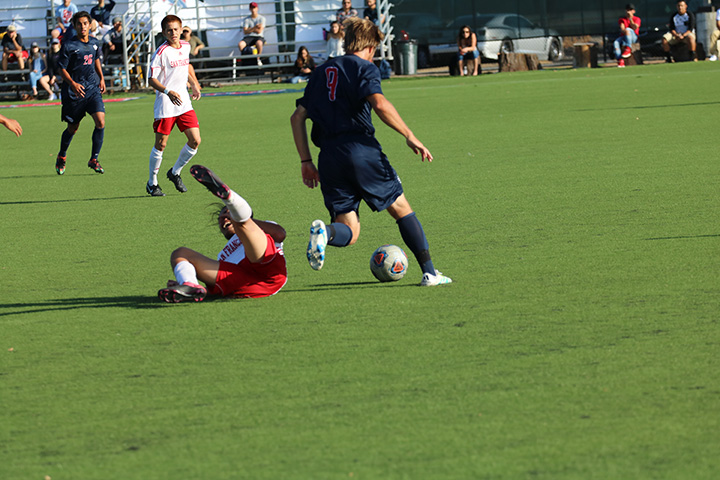 Dominic Laird fights off a would-be tackler and advances the ball up the pitch.